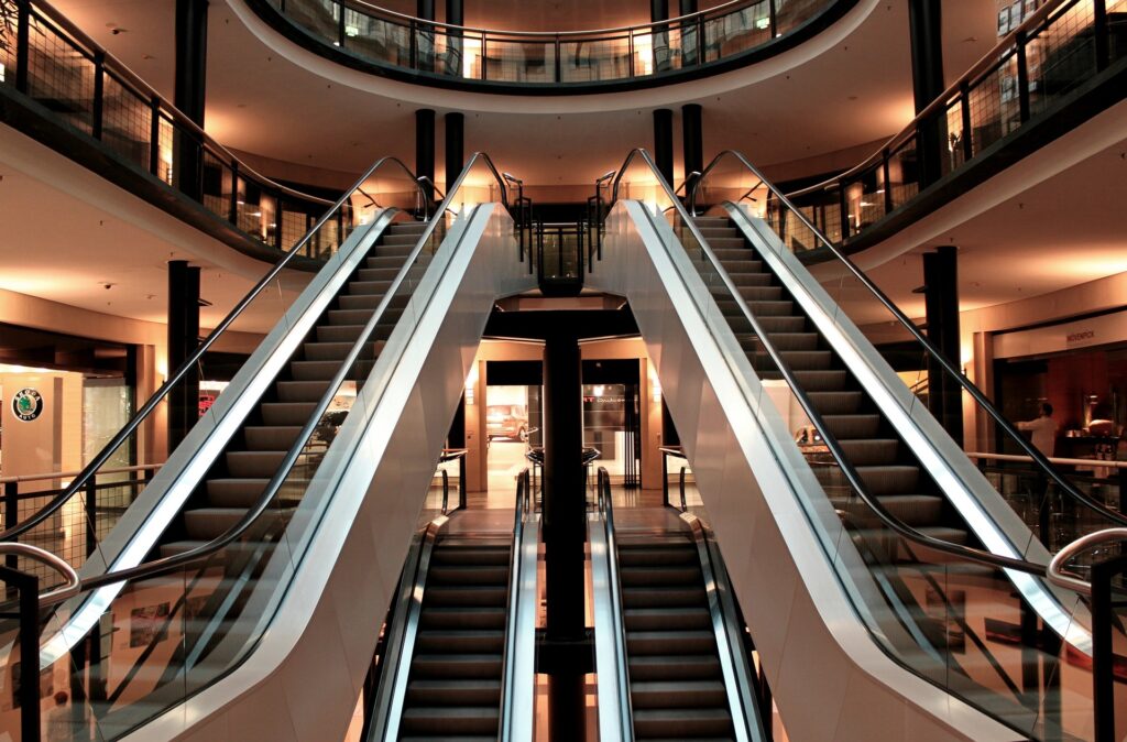 What is a depreciation schedule? A property investor’s guide » What is a depreciation schedule Commercial shopping centre interior with escalators, representing a commercial investment property eligible for a tax depreciation schedule