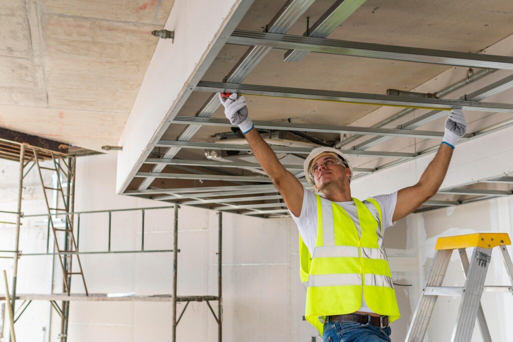 What is a depreciation schedule? A property investor’s guide » What is a depreciation schedule Builder installing ceiling framing during construction, representing plant and equipment assets claimable under Division 40 tax depreciation.