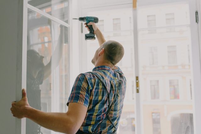 Division 40 vs Division 43: Capital Works and Plant and Equipment Explained » capital works Tradesperson installing a window in a residential investment property an example of capital works