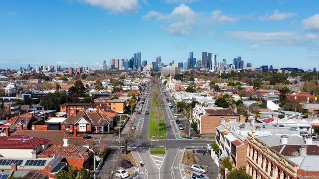 Aerial view of a residential street with the Melbourne CBD skyline in the background